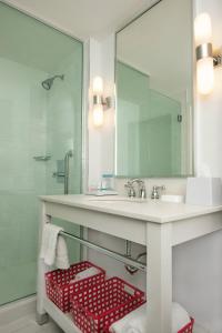 a bathroom with a sink and a mirror at Four Points by Sheraton Cambridge Kitchener, Ontario in Cambridge
