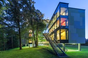 a glass house with a staircase leading up to it at Four Points by Sheraton Ljubljana Mons in Ljubljana