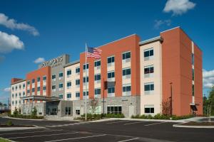 an office building with an american flag on top at Four Points by Sheraton Albany in Albany