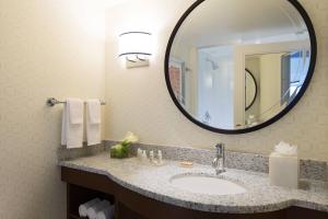 a bathroom with a sink and a large mirror at Renaissance Boston Waterfront Hotel in Boston