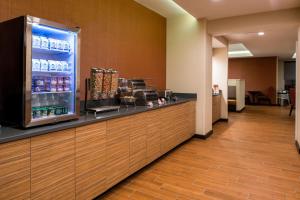 a lobby with a counter with a drink refrigerator at TownePlace Suites by Marriott Charleston-West Ashley in Charleston