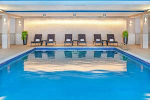 a pool in a hotel room with chairs in front of it at Sheraton Portsmouth Harborside Hotel in Portsmouth