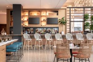 a restaurant with white chairs and a bar at JW Marriott Los Angeles L.A. LIVE in Los Angeles
