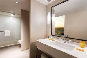 a bathroom with a sink and a mirror and a toilet at JW Marriott Los Angeles L.A. LIVE in Los Angeles