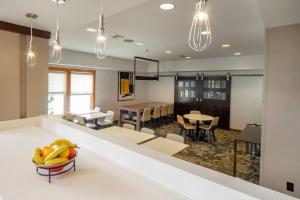 a kitchen and dining room with a bowl of bananas on a counter at Residence Inn by Marriott Hazleton in Hazleton