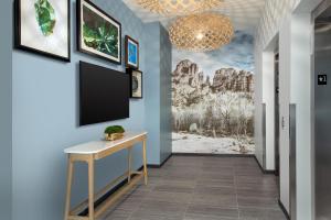 a hallway with a flat screen tv on a blue wall at Element Sedona in Sedona