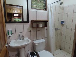 ein Bad mit einem Waschbecken, einem WC und einer Dusche in der Unterkunft Hospedaje Mariposa in Monteverde Costa Rica
