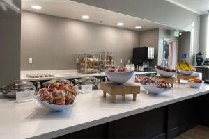 a buffet with bowls of food on a counter at Residence Inn by Marriott Sacramento Airport Natomas in Sacramento