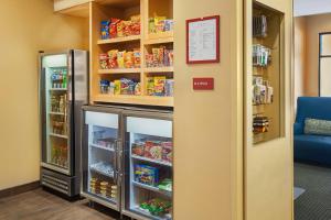 a room with an open refrigerator in a store at TownePlace Suites by Marriott Hobbs in Hobbs