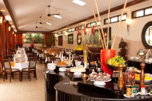 a restaurant with tables with food on them at Protea Hotel by Marriott Kampala in Kampala