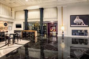 a large room with black marble floors and columns at Courtyard by Marriott Boston Downtown in Boston