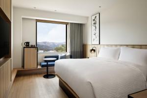 a hotel room with a bed and a window at Fairfield by Marriott Mie Okuise Odai in Odaicho