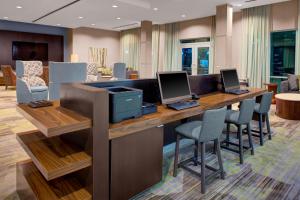 a office with two computers on a desk with chairs at Courtyard by Marriott Atlanta Kennesaw in Kennesaw