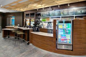 a bar in a restaurant with a refrigerator at Courtyard by Marriott Atlanta Kennesaw in Kennesaw