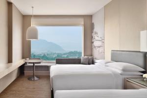 a hotel room with two beds and a window at Kathmandu Marriott Hotel in Kathmandu