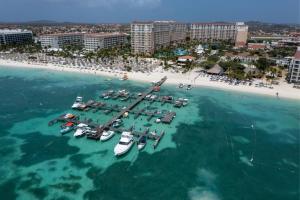 an aerial view of a beach with boats in the water at Marriott's Aruba Surf Club in Palm-Eagle Beach