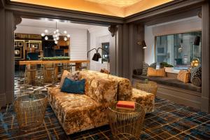 a living room with a couch and chairs and a kitchen at Courtyard by Marriott San Francisco Downtown/Van Ness Ave in San Francisco