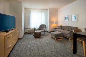 a living room with a couch and a tv at TownePlace Suites by Marriott Frederick in Frederick