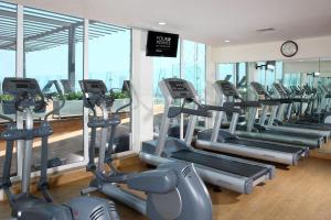 a gym with a row of treadmills and ellipticals at Four Points by Sheraton Veracruz in Veracruz