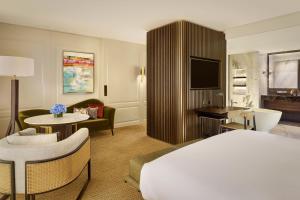 a hotel room with a bed and a living room at Penha Longa Resort in Sintra