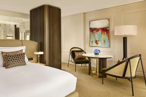 a hotel room with a bed and a table and chairs at Penha Longa Resort in Sintra