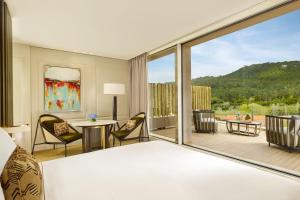 a hotel room with a bed and a large window at Penha Longa Resort in Sintra