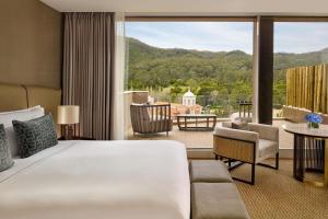 a hotel room with a bed and a large window at Penha Longa Resort in Sintra