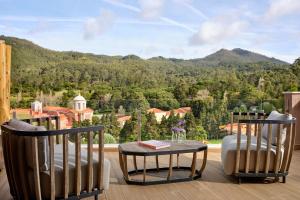a balcony with a table and chairs and a mountain view at Penha Longa Resort in Sintra