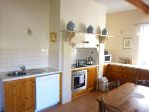a kitchen with a sink and a stove top oven at Robe House Heritage Accommodation in Robe