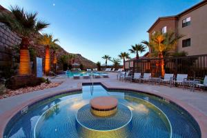 a swimming pool in the middle of a resort at TownePlace Suites St. George in St. George