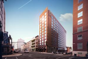 a tall building on a city street with buildings at Hotel Distil, Autograph Collection in Louisville