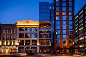 a building in a city with tall buildings at Hotel Distil, Autograph Collection in Louisville
