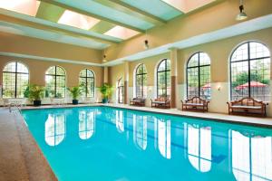 a swimming pool in a building with windows at Sheraton Parsippany Hotel in Parsippany