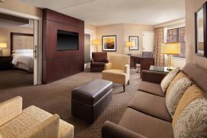 a hotel room with a couch and a bed at Sheraton Parsippany Hotel in Parsippany