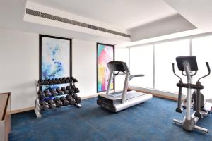 a gym with two exercise bikes and weights at Fairfield by Marriott Indore in Indore