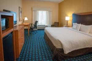 a hotel room with a large bed and a television at Fairfield Inn & Suites Orange Beach in Orange Beach