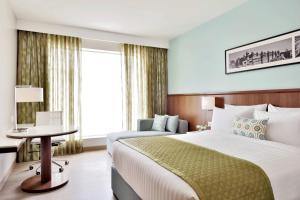 a hotel room with a bed and a table at Fairfield by Marriott Indore in Indore