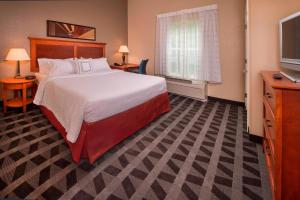 a hotel room with a bed and a television at TownePlace Suites by Marriott Clinton at Joint Base Andrews in Clinton