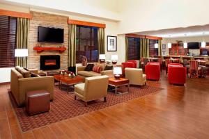 a living room with couches and chairs and a fireplace at Four Points by Sheraton Houston Hobby Airport in Houston