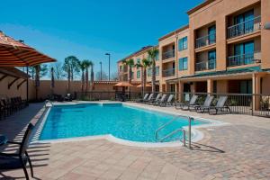 a swimming pool in front of a building at Courtyard Gulf Shores Craft Farms in Gulf Shores