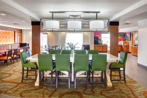 a conference room with a table and green chairs at Fairfield Inn & Suites by Marriott Toronto Brampton in Brampton