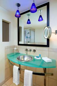 a bathroom with a sink and blue lights at Aloft Silicon Valley in Newark