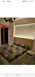 een slaapkamer met een bed met een quilt bij شقة بالاسكندرية سوبر لوكس بالمعمورة الشاطئ in New cairo