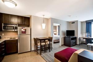 a hotel room with a kitchen and a living room at Residence Inn by Marriott Hamilton in Hamilton