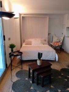 a bedroom with a large bed and a table at Casa Rocha Velha con piscina y terraza particular in Santiago de Compostela