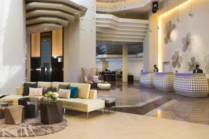 a lobby with couches and tables in a building at Renaissance Santo Domingo Jaragua Hotel & Casino in Santo Domingo