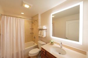 a bathroom with a sink and a toilet and a mirror at Sheraton Vistana Villages Resort Villas, I-Drive Orlando in Orlando