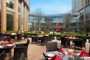 a restaurant with tables and chairs with red napkins at Sheraton Grand Shanghai Pudong Hotel & Residences in Shanghai