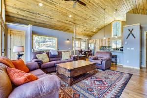 a living room with couches and a wooden ceiling at Family-Friendly Fairplay Cabin with Deck and Mtn Views in Fairplay