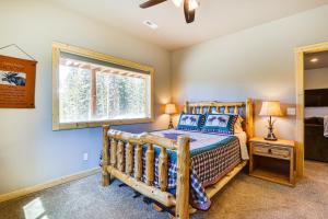 a bedroom with a wooden bed and a window at Family-Friendly Fairplay Cabin with Deck and Mtn Views in Fairplay